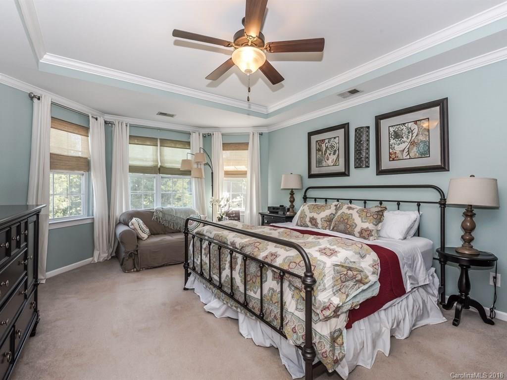 2002 Spanish Moss Road Indian Trail, NC 28079 - Photo 19 of 28 a bed room with a bed and a chandelier