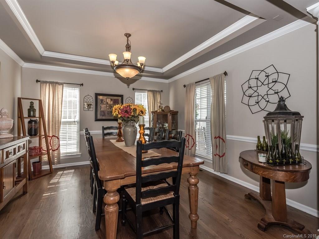 2002 Spanish Moss Road Indian Trail, NC 28079 - Photo 6 of 28 a view of a dining room with furniture wooden floor and chandelier