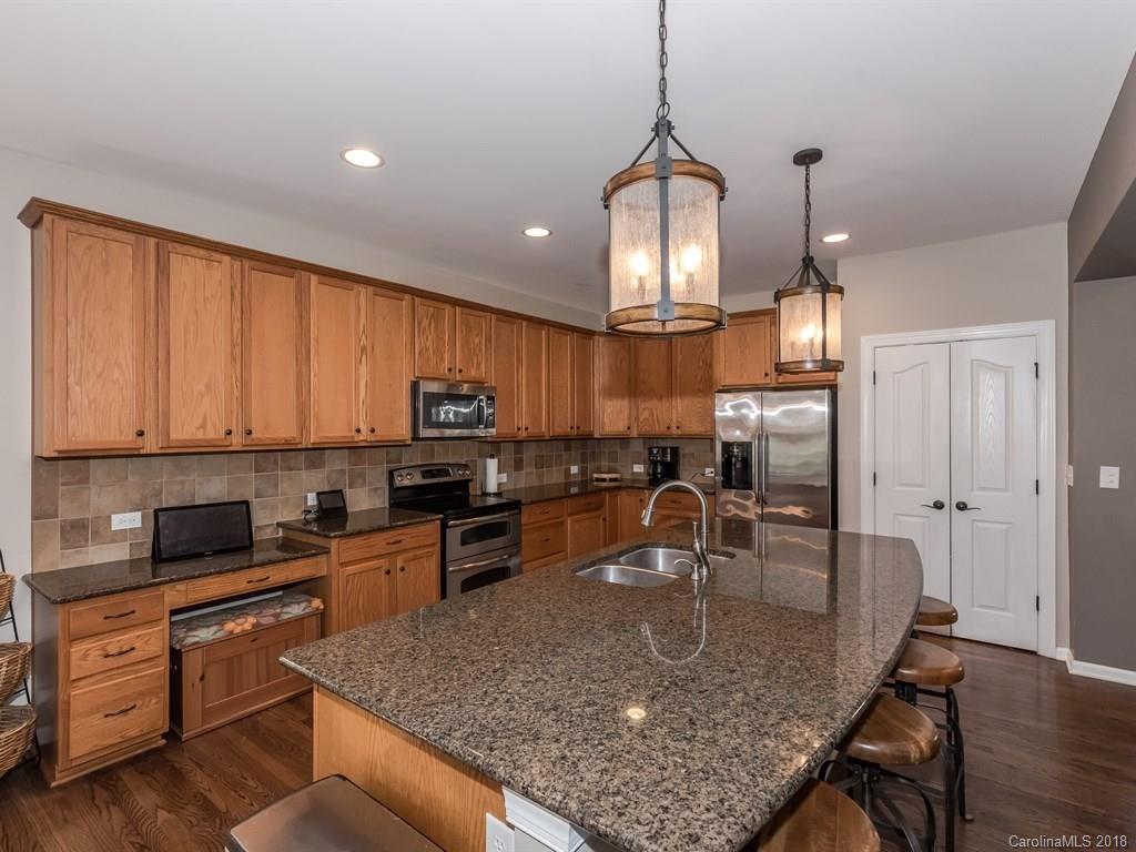 2002 Spanish Moss Road Indian Trail, NC 28079 - Photo 9 of 28 a kitchen with stainless steel appliances granite countertop a sink a stove counter space and cabinets