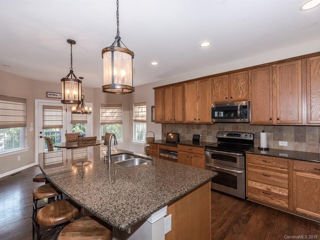 2002 Spanish Moss Road Indian Trail, NC 28079 - Photo 10 of 28 a kitchen with stainless steel appliances granite countertop a sink a stove and cabinets