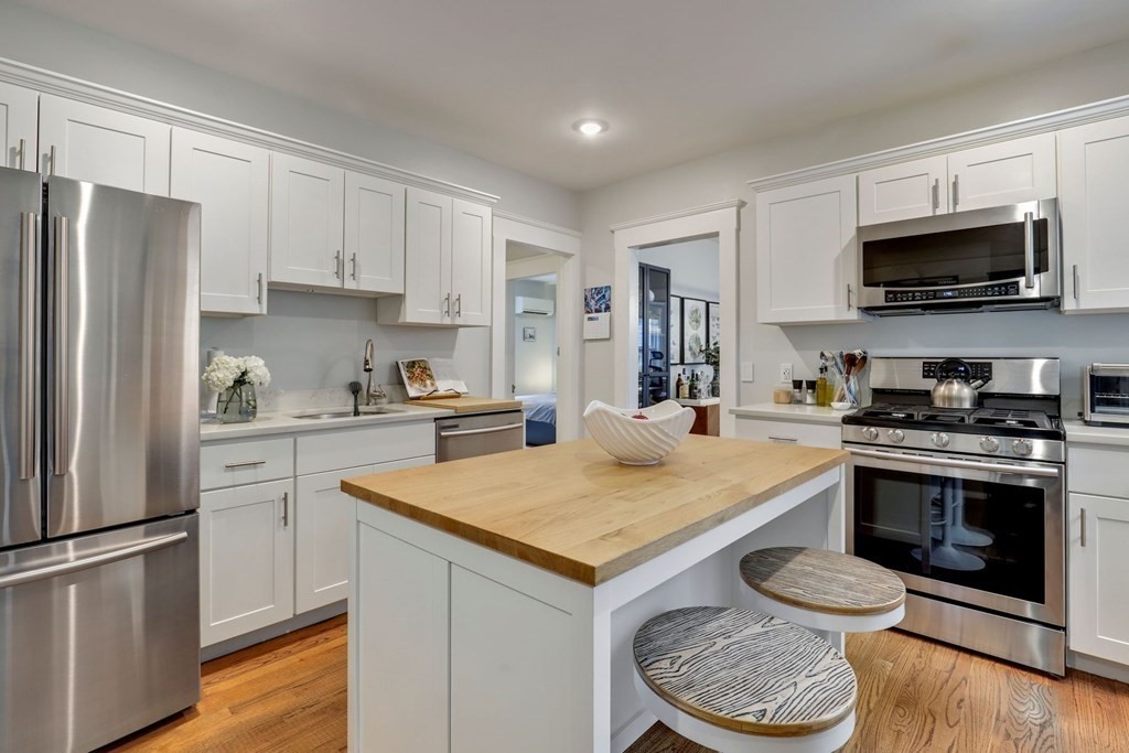 71-73 Brookley Road, Unit 1 Boston, MA 02130 - Photo 11 of 28 a kitchen with a white stove top oven and refrigerator