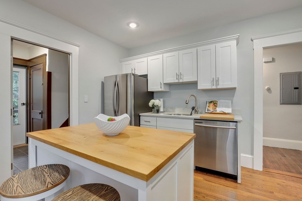 71-73 Brookley Road, Unit 1 Boston, MA 02130 - Photo 12 of 28 a kitchen with stainless steel appliances granite countertop a sink stove and refrigerator