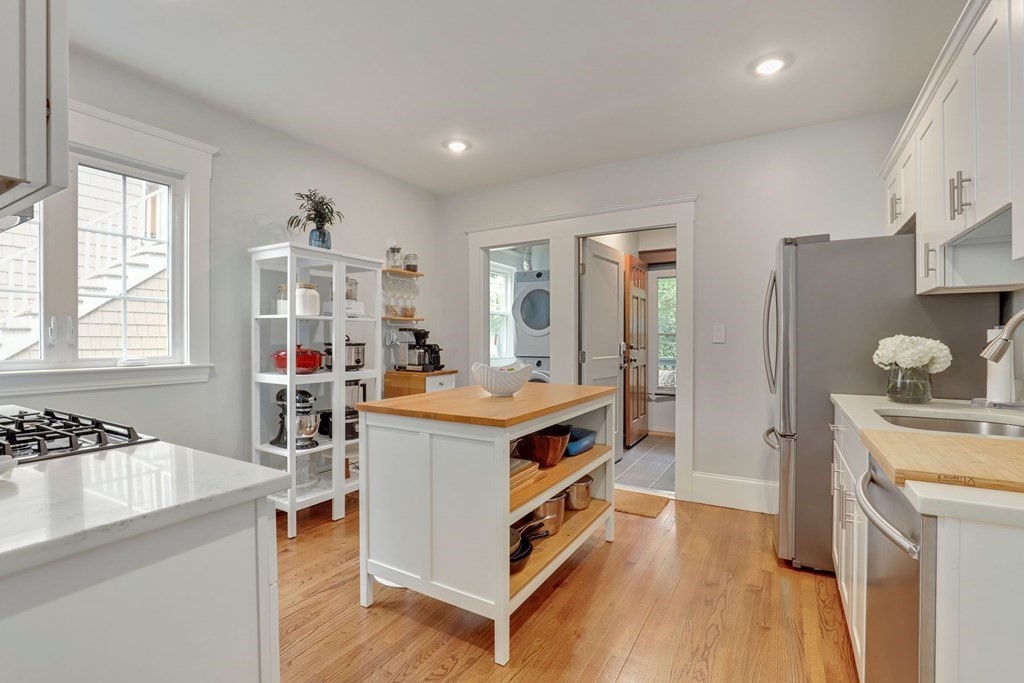 71-73 Brookley Road, Unit 1 Boston, MA 02130 - Photo 14 of 28 a kitchen with a stove cabinets and wooden floor
