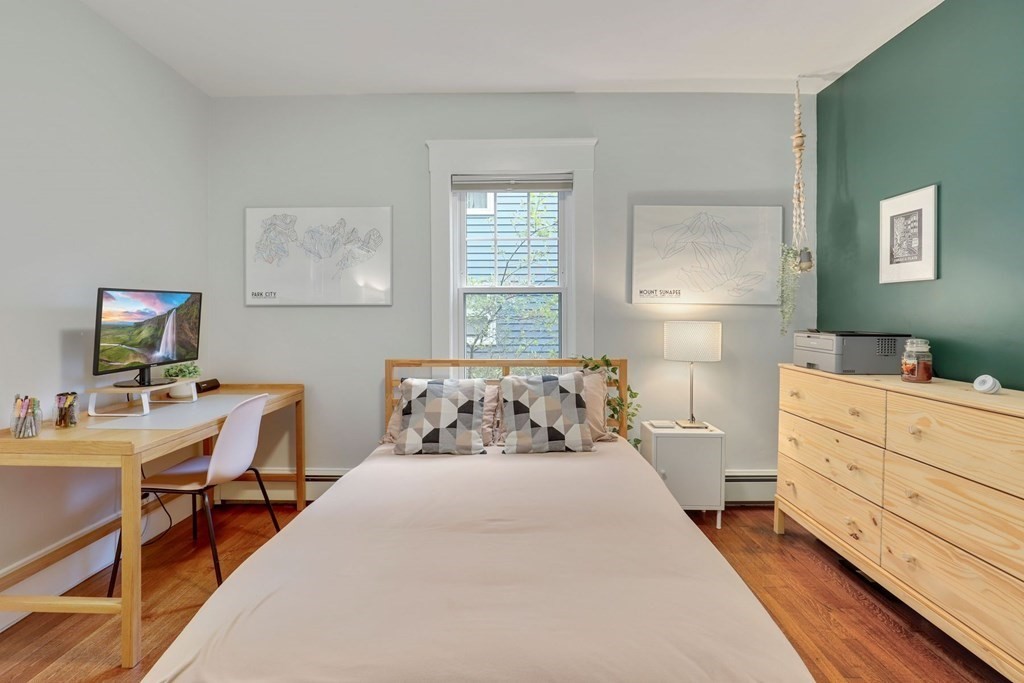 71-73 Brookley Road, Unit 1 Boston, MA 02130 - Photo 16 of 28 a bed room with a bed and a table