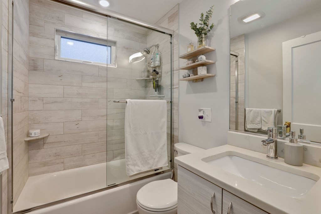 71-73 Brookley Road, Unit 1 Boston, MA 02130 - Photo 17 of 28 a bathroom with a granite countertop sink toilet and shower