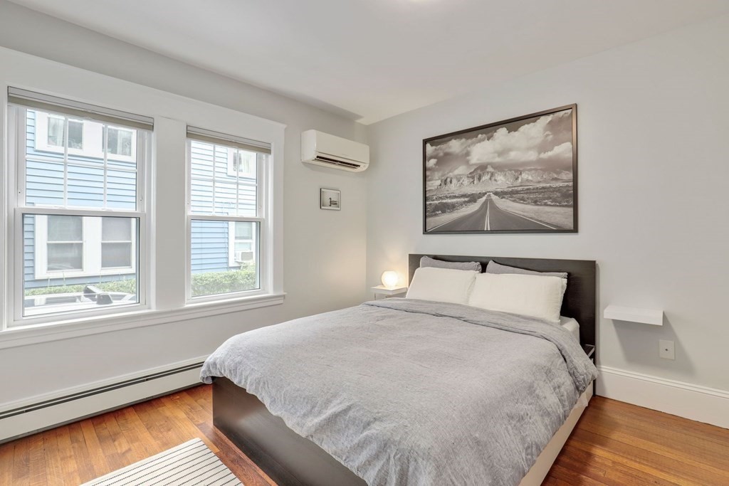 71-73 Brookley Road, Unit 1 Boston, MA 02130 - Photo 18 of 28 a large bed sitting in a bedroom next to a window