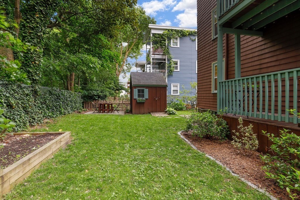 71-73 Brookley Road, Unit 1 Boston, MA 02130 - Photo 25 of 28 a view of a house with a yard and plants