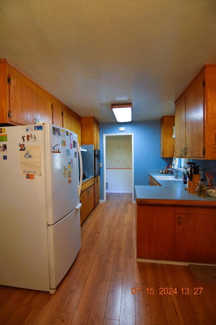 3909 Paladin Drive San Jose, CA 95124 - Photo 12 of 20 a kitchen with granite countertop a refrigerator and a stove top oven