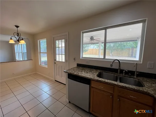 a kitchen with granite countertop a sink and a granite counter tops