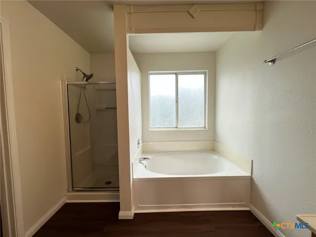 a bathroom with a glass shower door