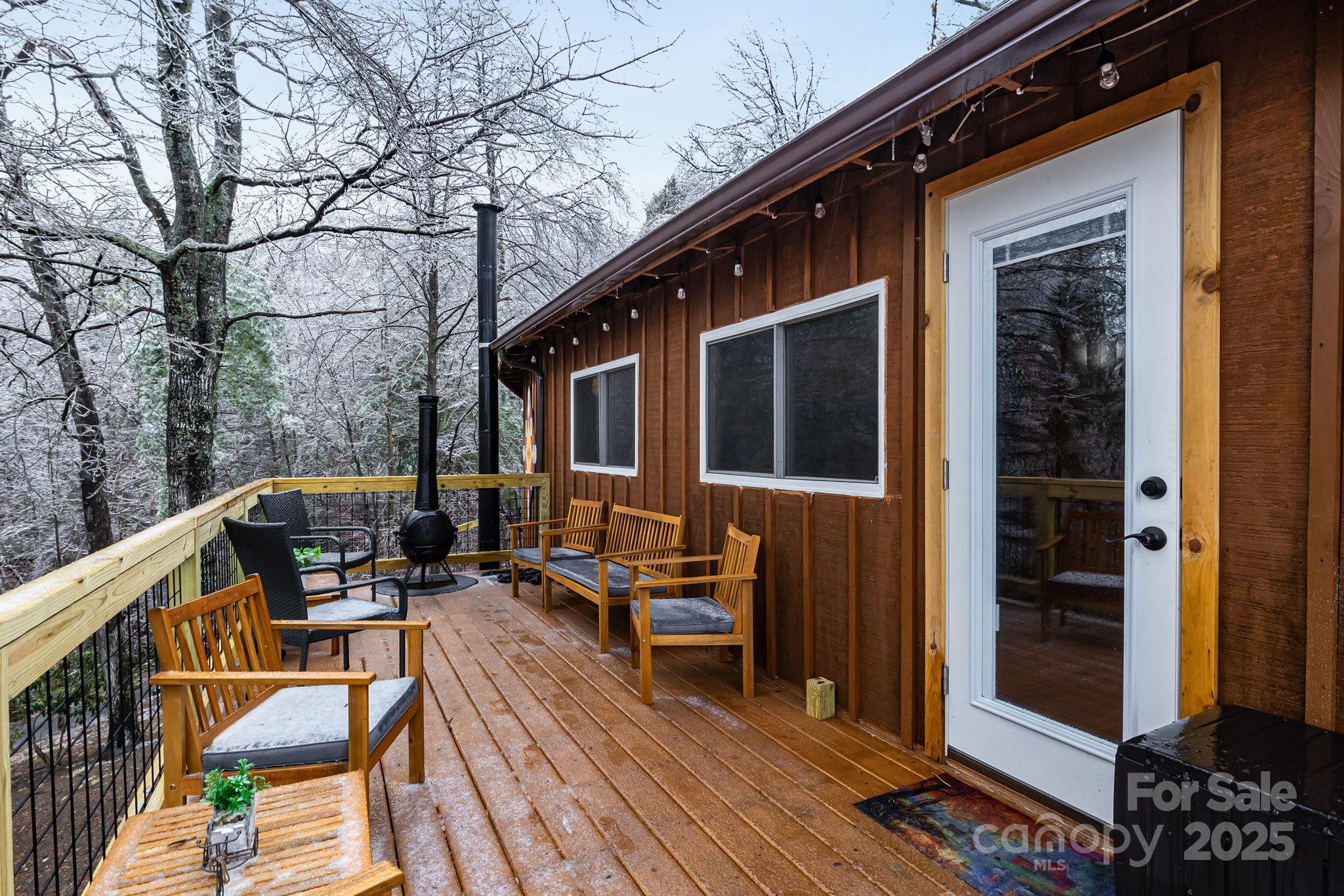 433 Waterfall Road Millers Creek, NC 28651 - Photo 14 of 16 a balcony of a house with wooden floor and outdoor seating