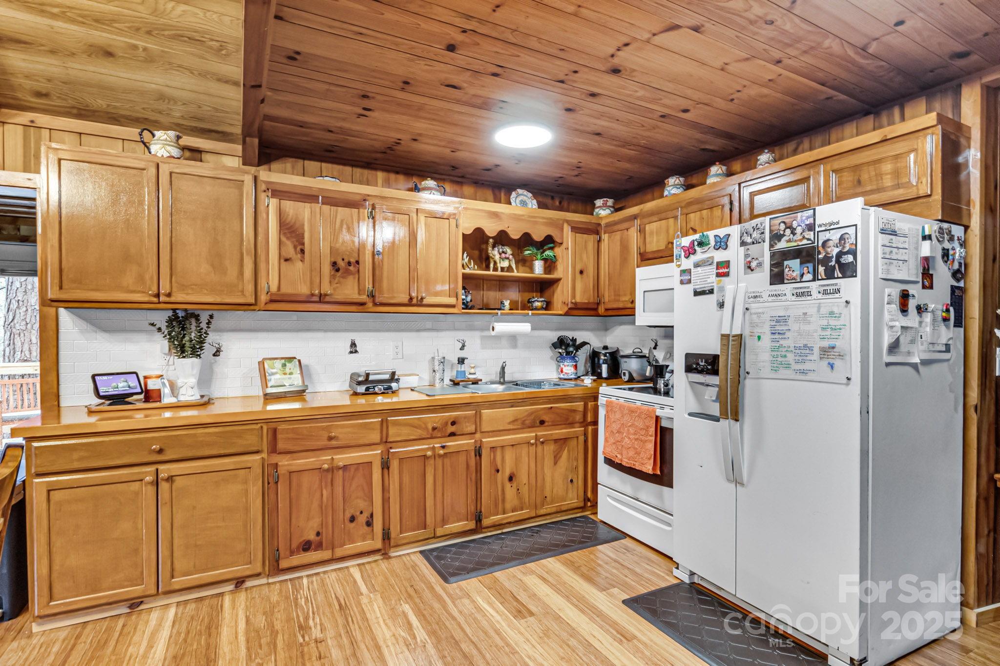 433 Waterfall Road Millers Creek, NC 28651 - Photo 6 of 16 a kitchen with stainless steel appliances granite countertop a refrigerator and wooden cabinets