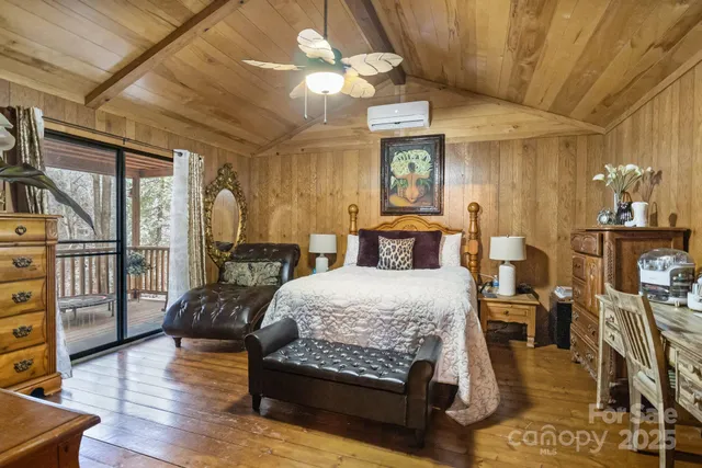 a bedroom with a bed a bookshelf and wooden floor