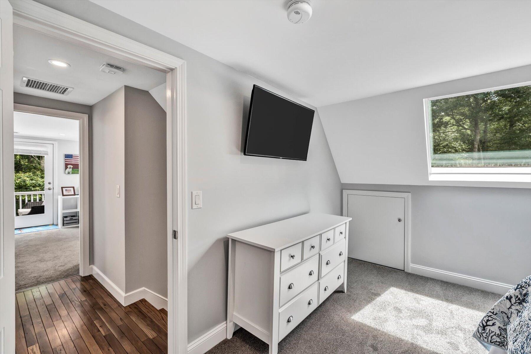 75 The Hunt Circle Mashpee, MA 02649 - Photo 33 of 49 a spacious bedroom with a bed and a flat screen tv