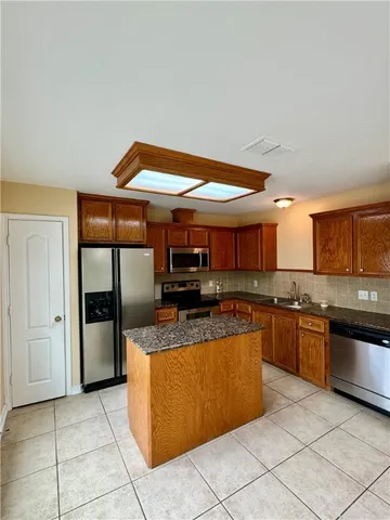 a kitchen with stainless steel appliances granite countertop a stove and a sink