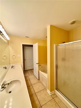 a spacious bathroom with a granite countertop sink and a mirror