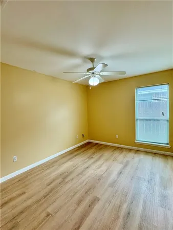 an empty room with a empty space and a ceiling fan