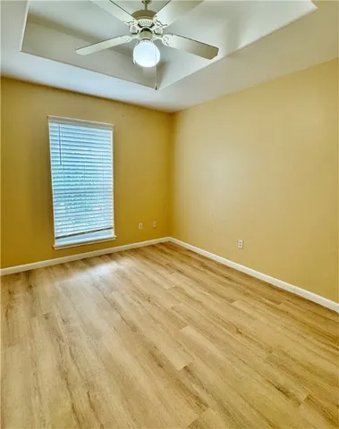 a view of a room with wooden floor and fan