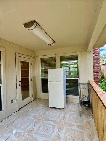 a view of kitchen with furniture and refrigerator