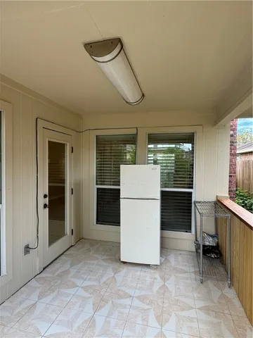a view of kitchen with furniture and refrigerator