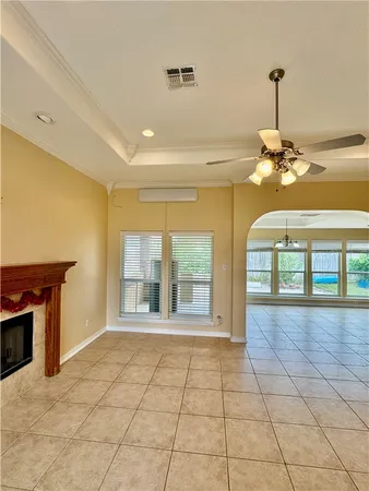 a view of a room with a chandelier and fireplace
