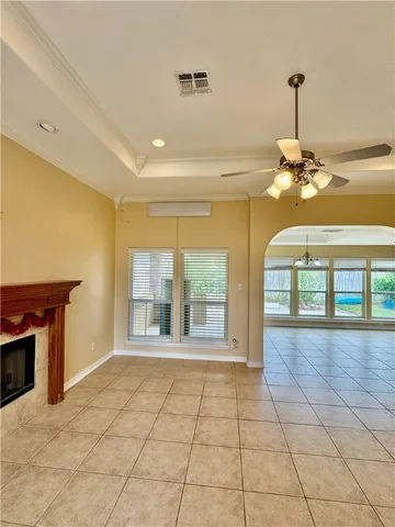 a view of a room with a chandelier and fireplace