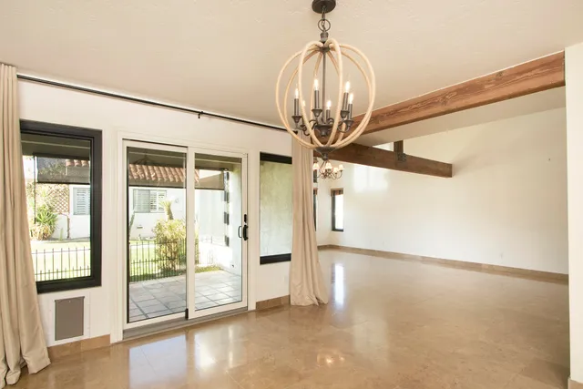 a view of a livingroom with wooden floor and a chandelier