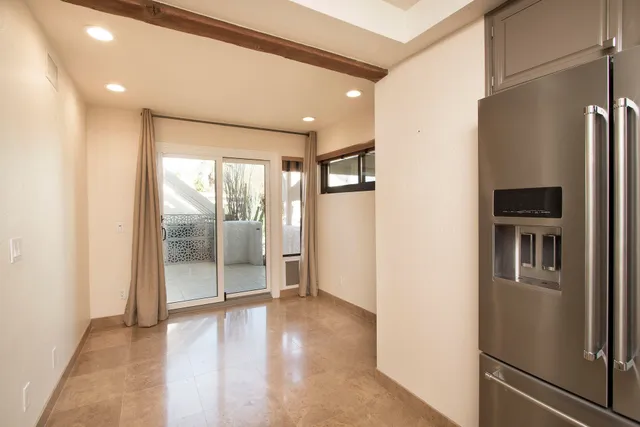 a view of a refrigerator in kitchen and wooden floor