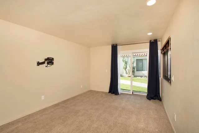 a view of a room with an empty space and a window