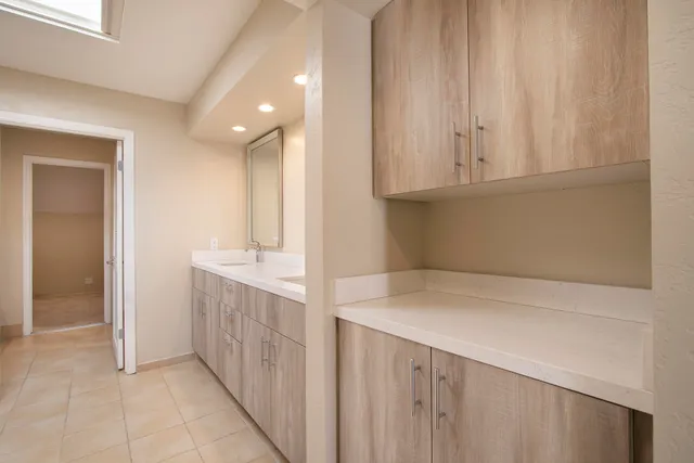 a bathroom with a double vanity sink and a mirror