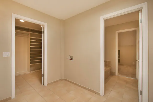 a view of walk in closet with empty racks