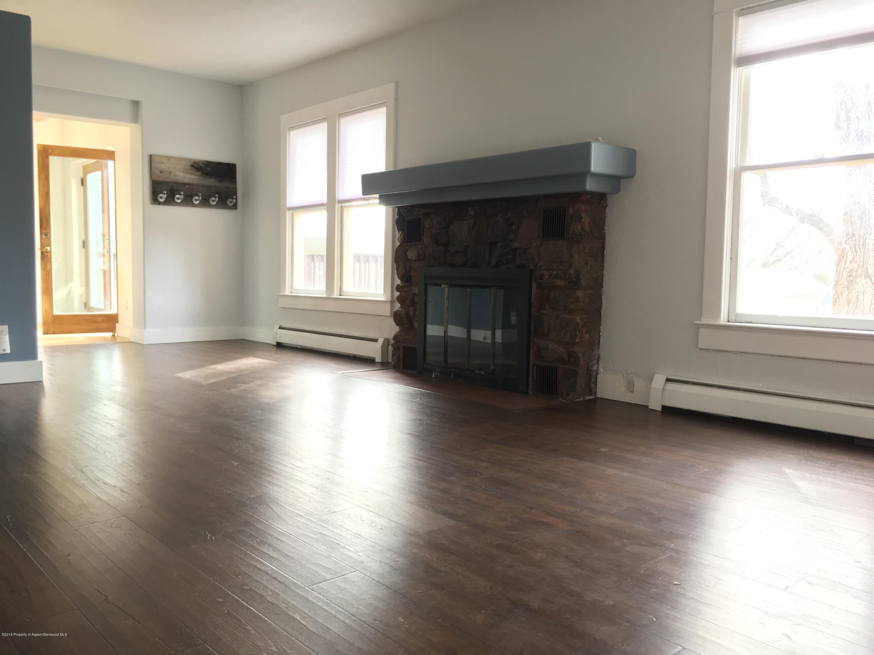 301 East 7th Street Rifle, CO 81650 - Photo 13 of 25 a view of a livingroom with wooden floor and a fireplace