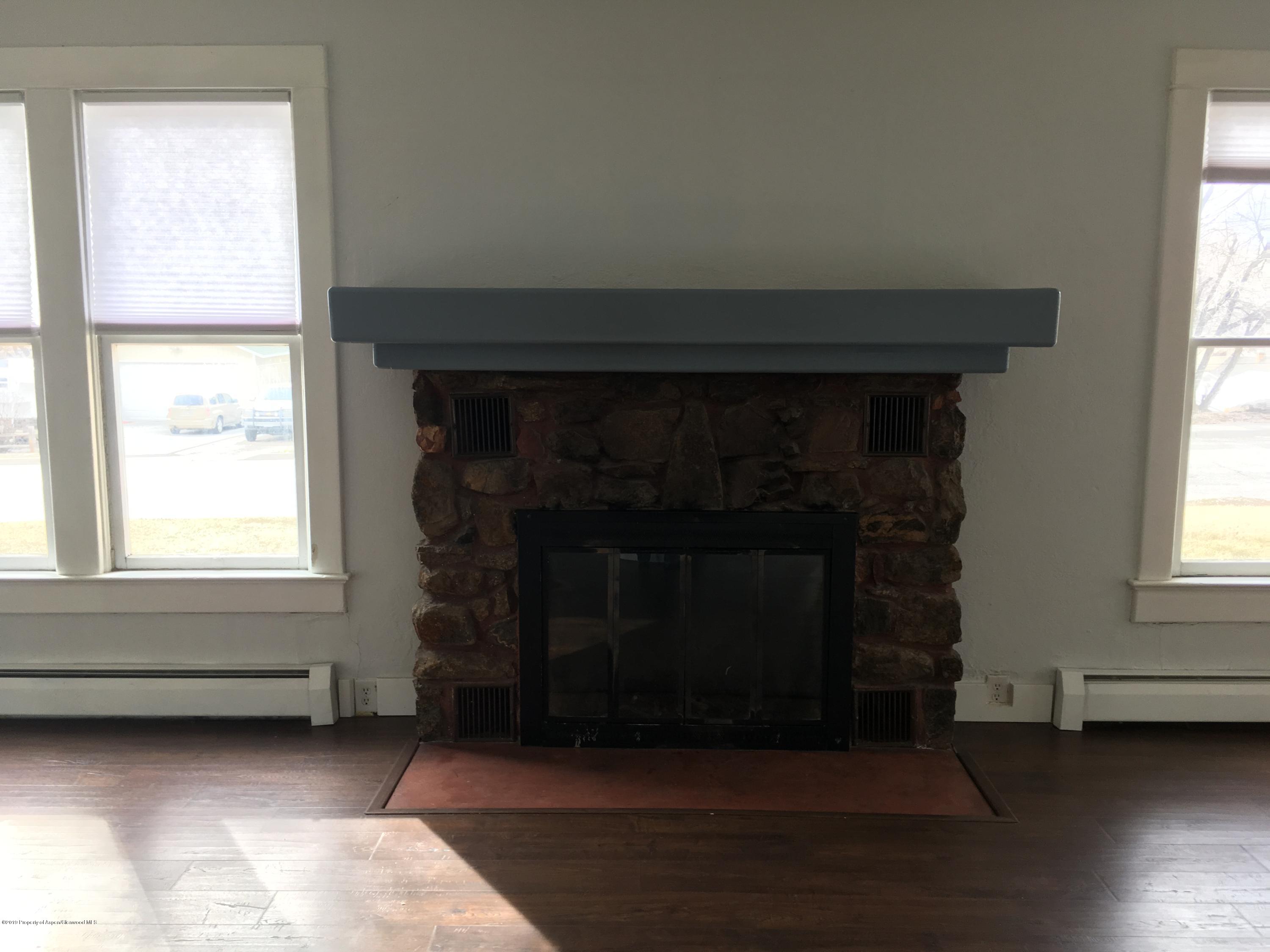 301 East 7th Street Rifle, CO 81650 - Photo 14 of 25 a living room with furniture and a fireplace