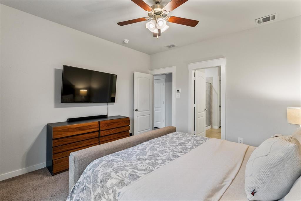 2407 Neff Lane Forney, TX 75126 - Photo 9 of 22 a bedroom with a bed and a flat screen tv