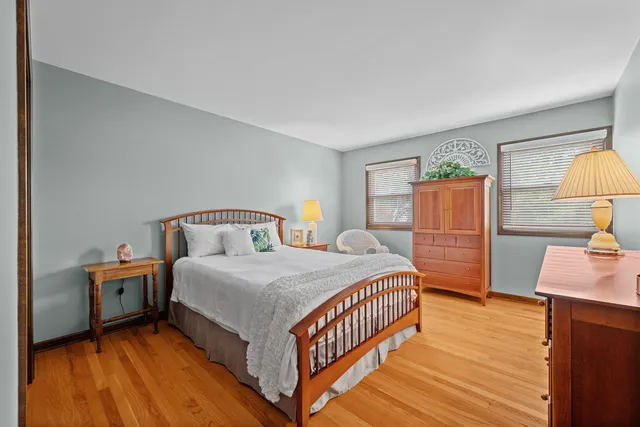 a bedroom with a bed and a lamp on table