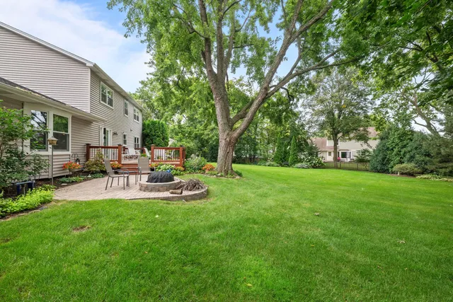 a view of backyard with swimming pool and patio