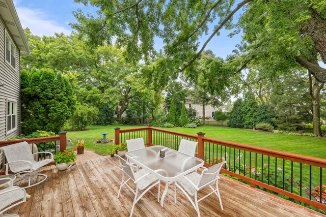 a view of a patio with a table chairs and a backyard