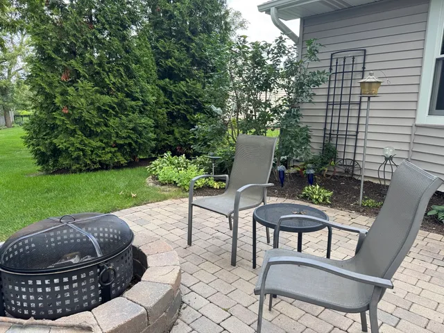 a view of a porch with furniture and a yard