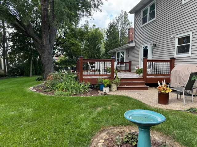 a view of a house with backyard and a slide