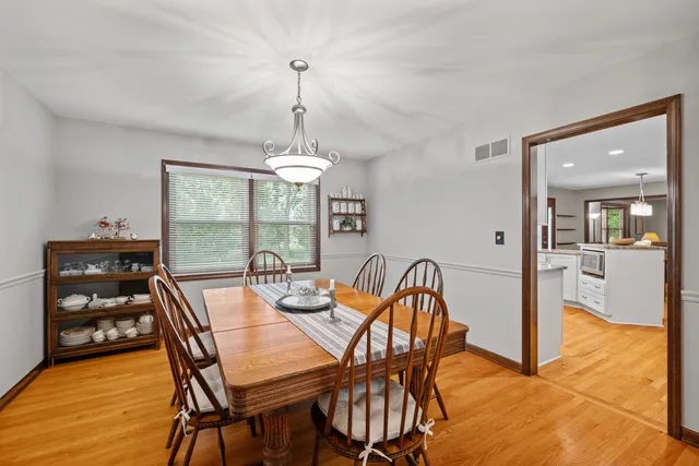 a dining room with furniture and window
