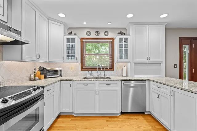 a kitchen with a sink stove and cabinets