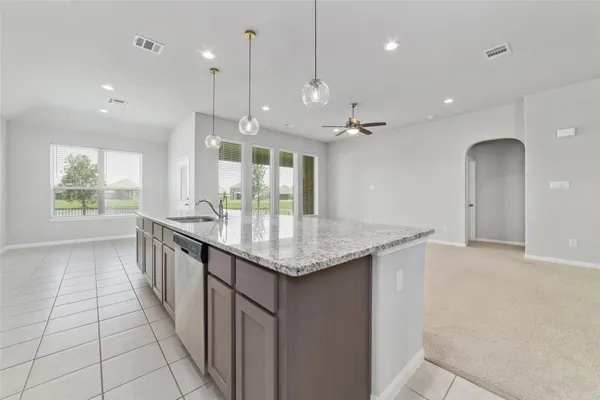 a kitchen with granite countertop a large stove a sink and a refrigerator