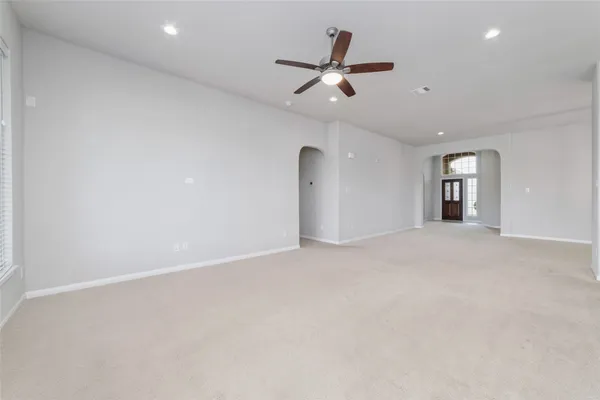 an empty room with closet and windows