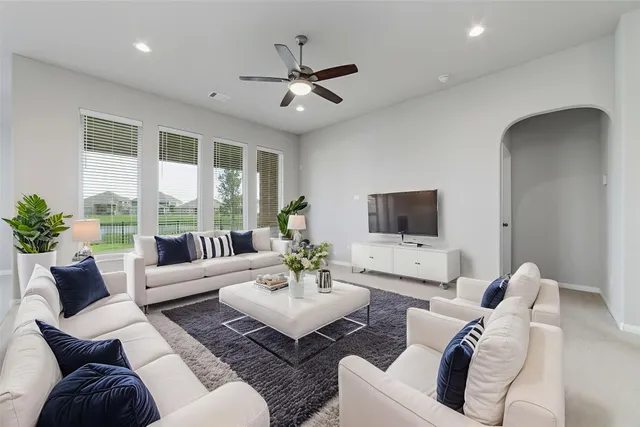 a living room with furniture and a large window
