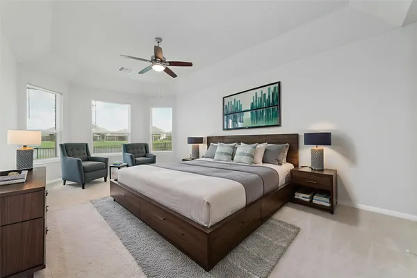 a spacious bedroom with a bed and window