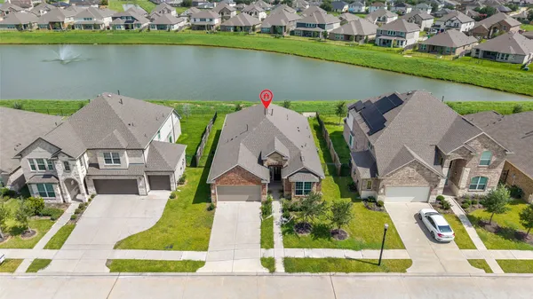 an aerial view of a house with a lake view
