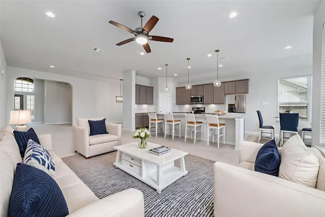 a living room with furniture and kitchen view