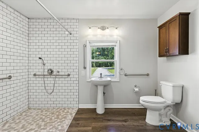 a bathroom with a sink a toilet and mirror