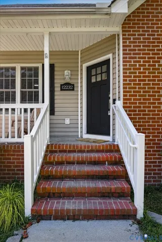 a view of staircase with wooden floor and windows