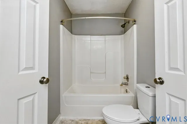 a bathroom with a toilet and a bathtub